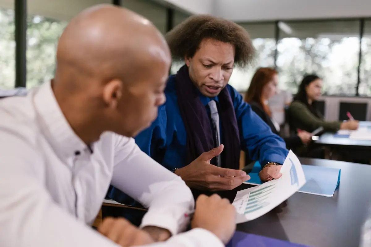 Two colleagues reviewing work together during a mentoring session